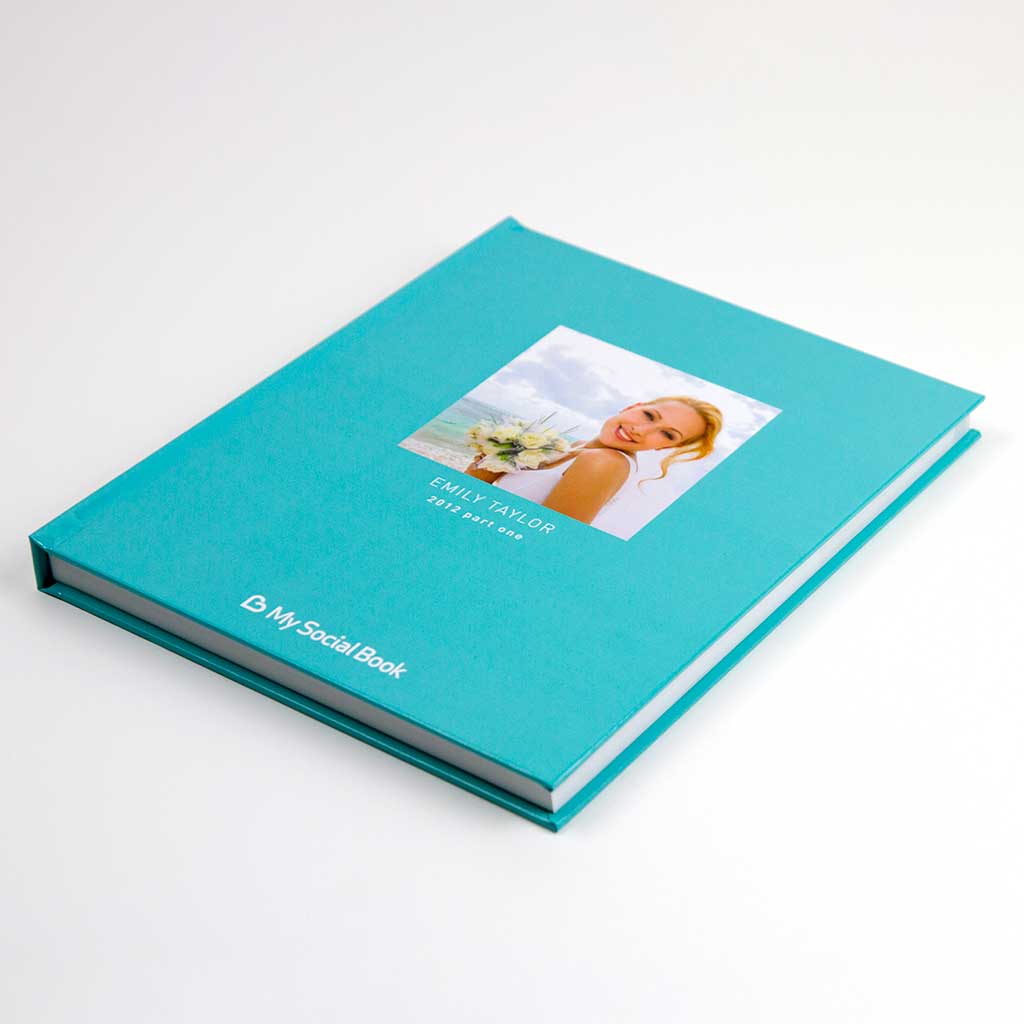 Facebook albums photo book — open book showing photos imported from a Facebook album with captions and dates