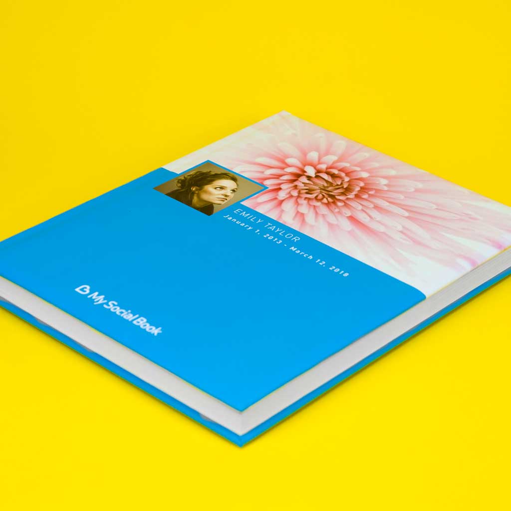 Facebook photo book — open book showing imported posts, photos, and dates from a Facebook timeline